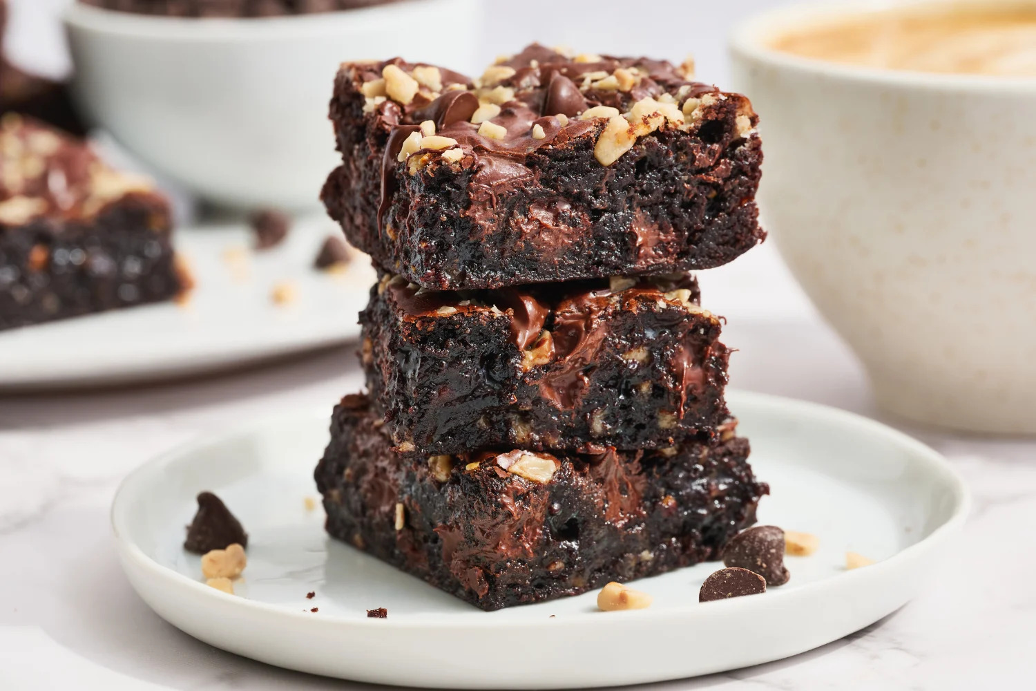 A slice of toffee brownie on a plate with a bite taken out
